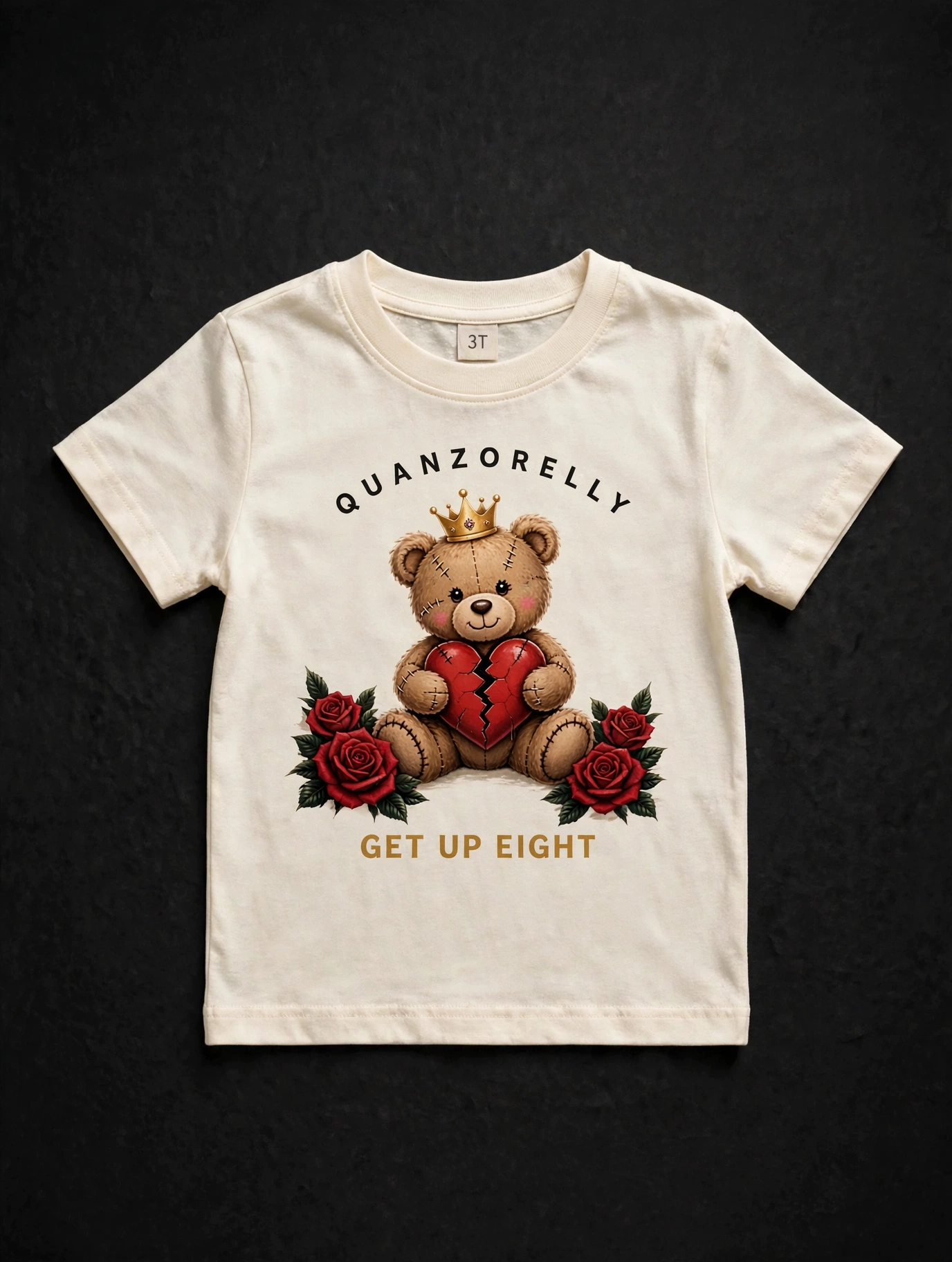 Toddler Teddy tee — cream toddler tee with the crowned stitched teddy hugging a cracked red heart between two red roses, GET UP EIGHT in small gold letters